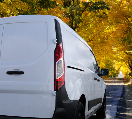 Van driving through picturesque road to promote fleet insurance by Evalee Insurance Brokers