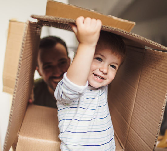 Young boy playing inside a cardboard box to promote home insurance by Evalee Insurance Brokers