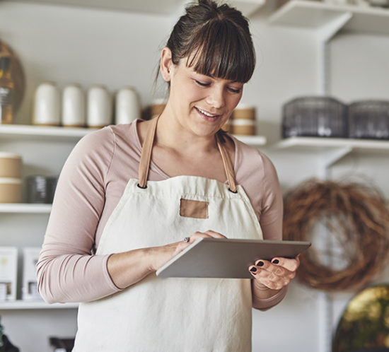 Female cafe owner ordering supplies on ipad to promote commercial combined insurance by Evalee Insurance Brokers