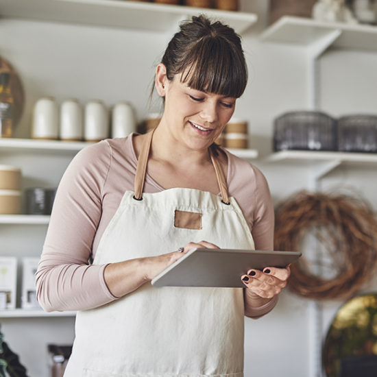 Female cafe owner ordering supplies on ipad to promote commercial combined insurance by Evalee Insurance Brokers