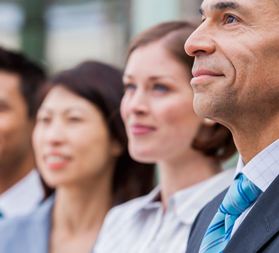 Senior staff stood looking admiringly into distance to promote directors and officers insurance by Evalee Insurance Brokers