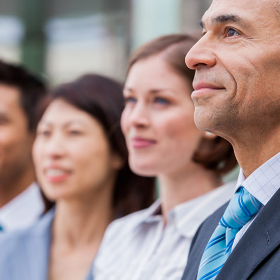 Senior staff stood looking admiringly into distance to promote directors and officers insurance by Evalee Insurance Brokers