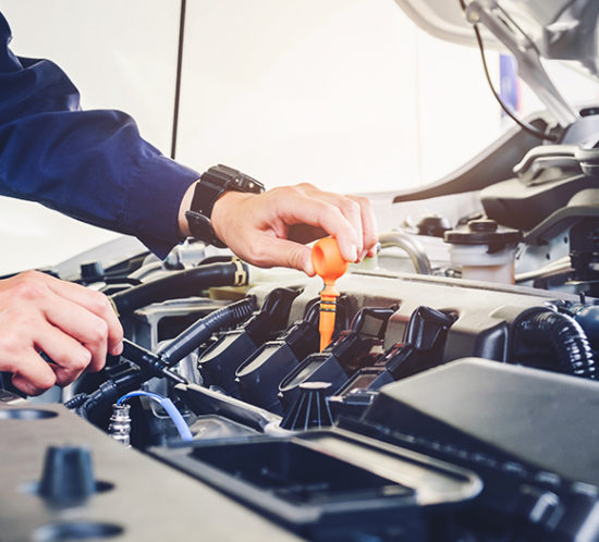 Mechanic working on car to promote motor trade insurance by Evalee Insurance Brokers