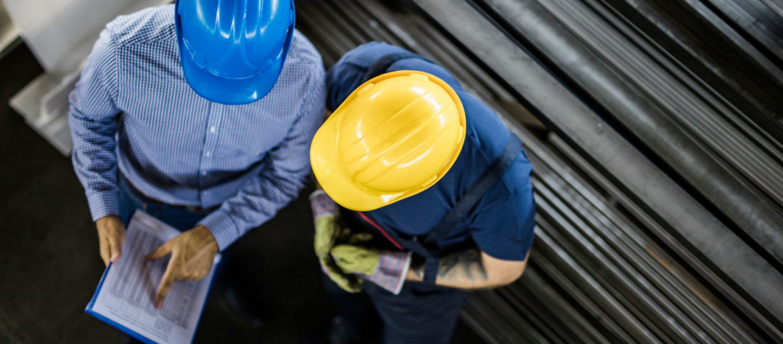 Two construction workers in conversation to promote construction insurance by Evalee Insurance Brokers