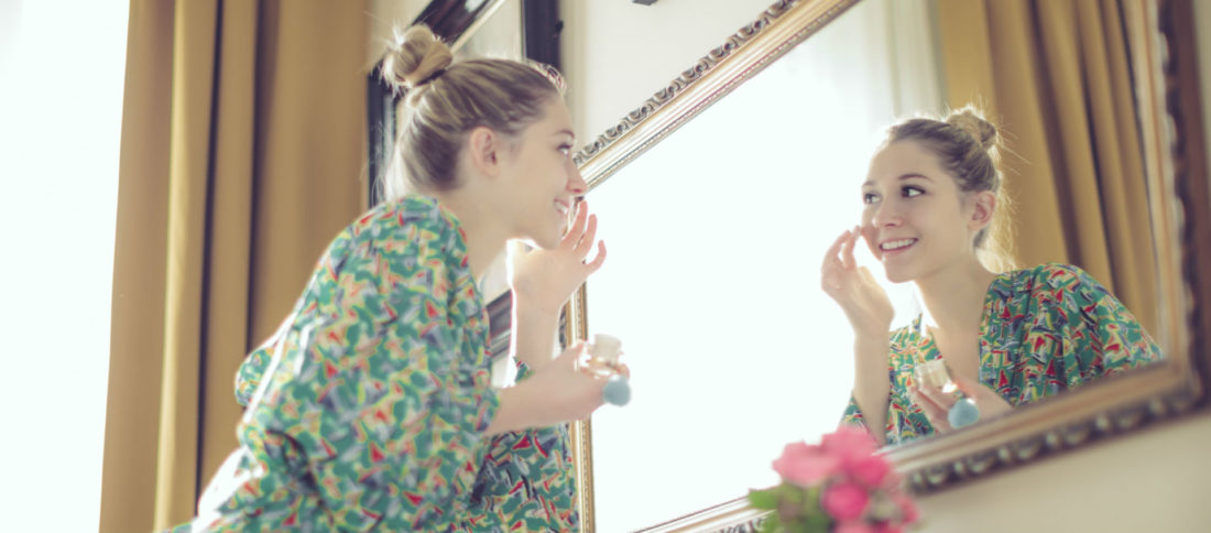 Woman getting ready for work in mirror to promote Evalee Insurance Brokers - Car Insurance